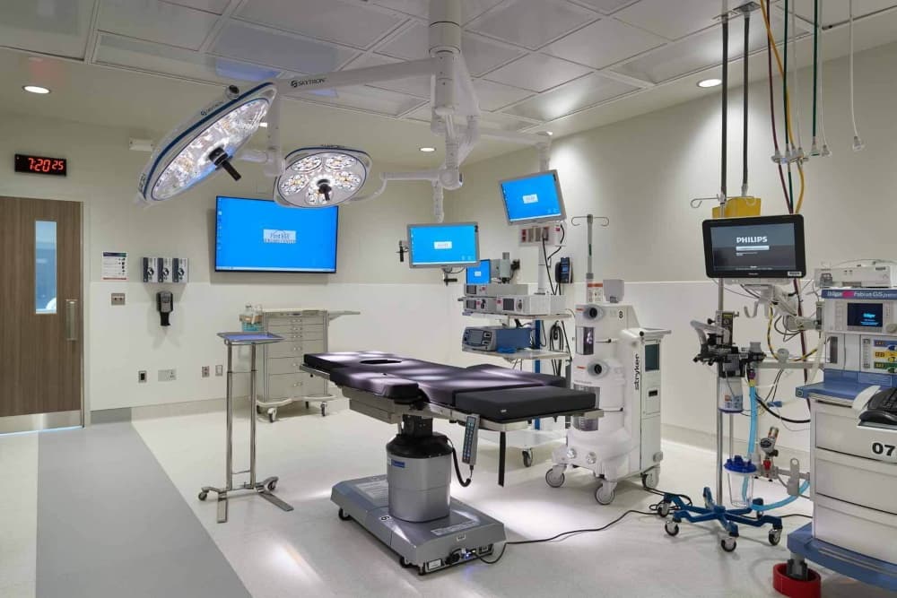 Fully equipped hospital operating room with ceiling-mounted surgical booms, integrated monitors, and isolated power systems installed by H&M Electric